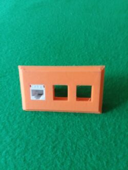 One of my earliest functional FDM prints — a custom-fit keystone plate made to snap into an existing conference table panel.