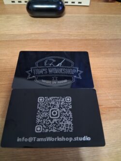 Custom metal business cards laser engraved with the Tam’s Workshop logo on the front, and a scannable Instagram QR code + contact info on the back.