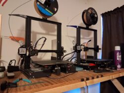 My current 3D printing setup: a pair of Ender 3 printers upgraded for reliability, quiet operation, and remote print management.