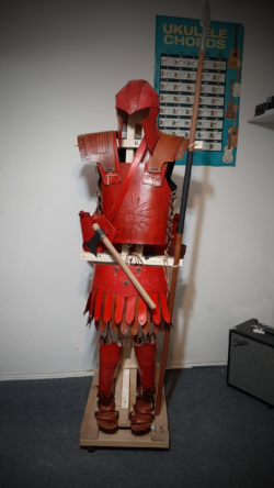 Handcrafted Roman-era inspired armor in vegetable tanned leather, featuring a full kit with helmet, cuirass, pteruges, greaves, and Greek-style sandals.